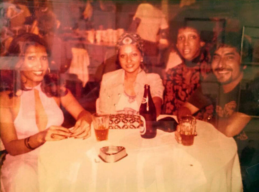 Download the full-sized image of A Photograph of Marlow Monique Dickson and Others Posing Around a Table