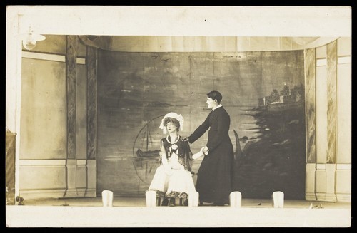 Download the full-sized image of Two men in drag acting on stage. Photographic postcard. 1905-1910.