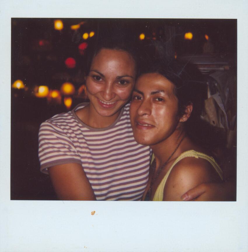 Download the full-sized image of A Polaroid of Melissa Posing with a Person in a Striped Shirt