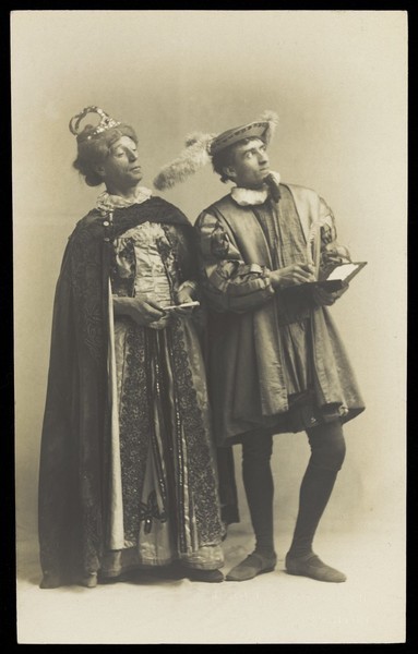 Download the full-sized image of Actors in pantomime in Brighton: S. West playing King Robert of Remlaf and H. Taylor in drag as Queen Aggie of Remlaf. Photographic postcard.