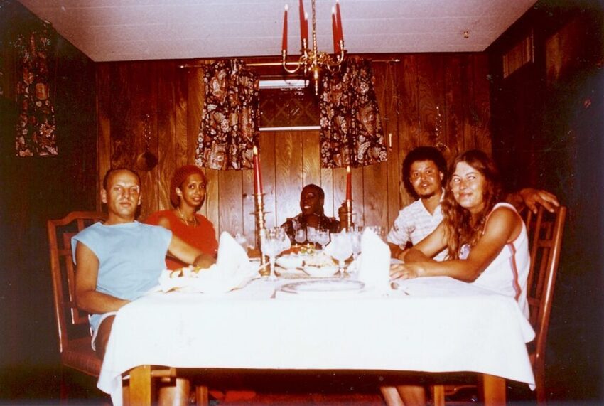 Download the full-sized image of A Photograph of Marlow Monique Dickson Sitting with Others at a Dinner Table