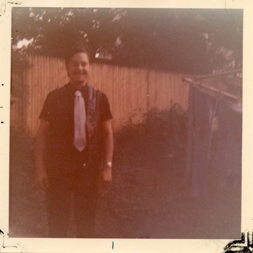 Download the full-sized image of Photograph of Rupert Raj in front of a Fence