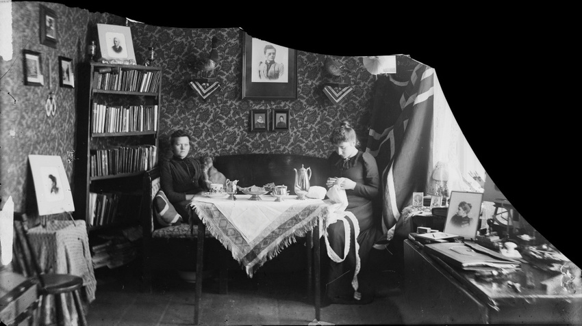 Download the full-sized image of Marie Høeg sits with Tuss and an Unknown Individual at a Table