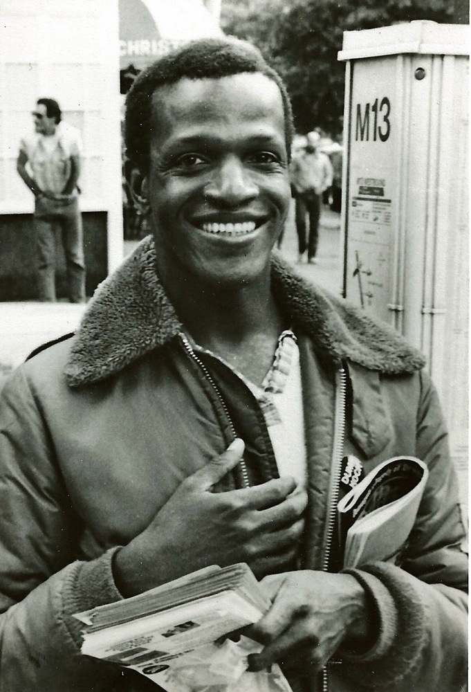 Download the full-sized image of A Photograph of Marsha P. Johnson Wearing a Bomber Jacket and Holding Magazines