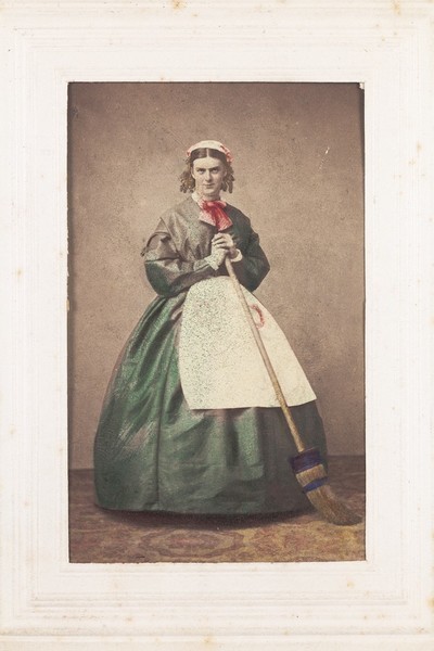 Download the full-sized image of A man in drag holding a broom. Photograph, 1862.
