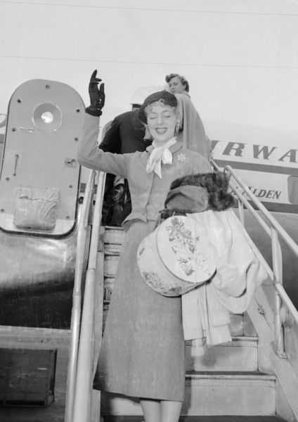 Download the full-sized image of Christine Jorgensen Waves from Airplane Steps
