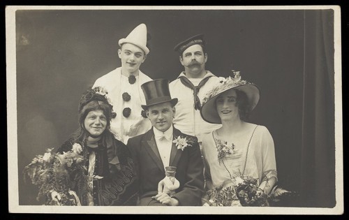 Download the full-sized image of A comedy wedding with the bride in drag. Photographic postcard, ca. 1922.