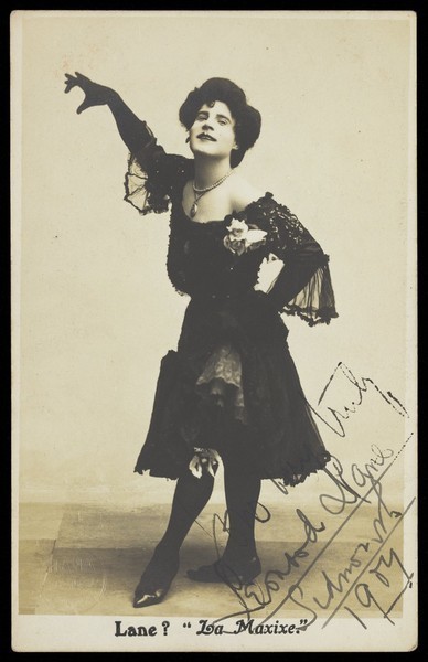 Download the full-sized image of Leonard Lane, dressed as a woman, dancing. Photographic postcard, 1907.