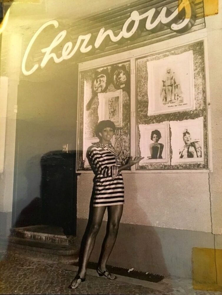 Download the full-sized image of A Photograph of Marlow Monique Dickson Posing in Front of Chez Nous