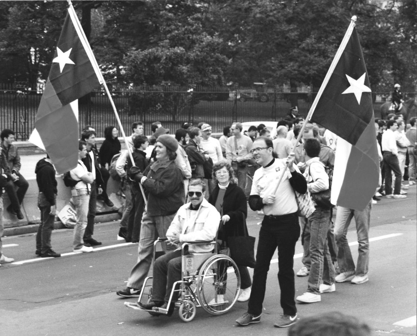 Download the full-sized image of Phyllis Frye Carries the Texas Flag In the 1986 March on Washington for Lesbian and Gay Rights