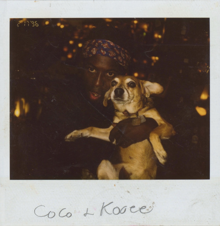 Download the full-sized image of A Polaroid of Cocoa Rodriguez Holding a Small Dog