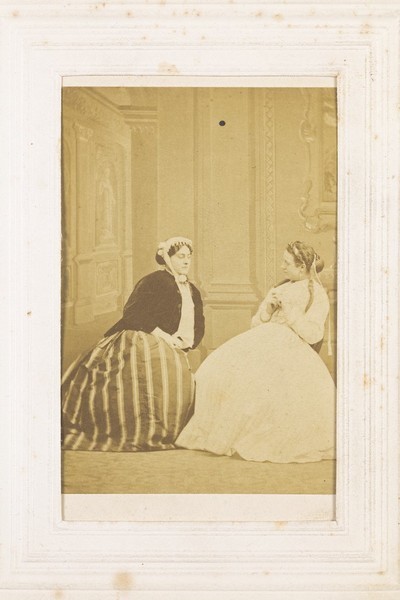 Download the full-sized image of Two men in drag sitting in conversation. Photograph, 1855/1860.