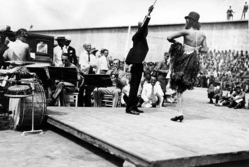 Download the full-sized image of Stage entertainment with musicians and two male dancers (one in female dress), San Quentin Little Olympics Field Meet, 1930