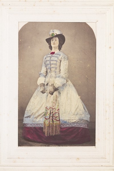 Download the full-sized image of A man in drag dressed as a distinguished-looking young woman. Photograph, 189-.