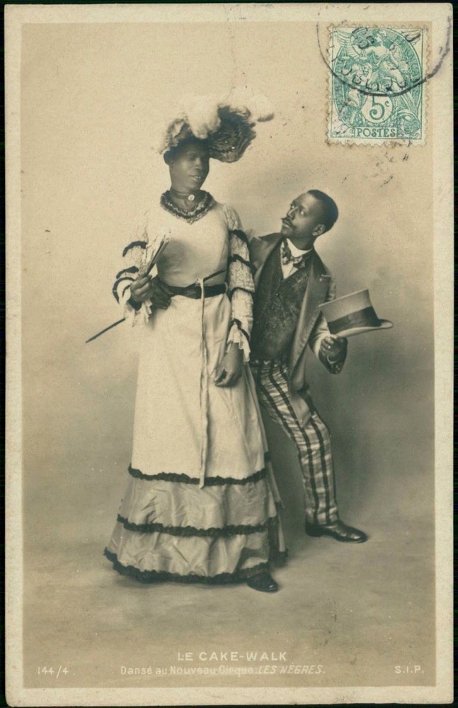 Download the full-sized image of Jack Brown Poses in Drag in Front of Dance Partner Charles Gregory, Holding a Fan