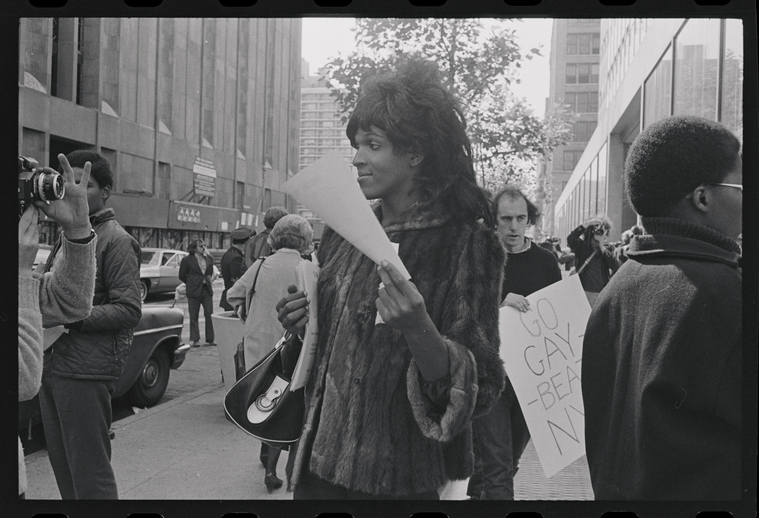 Download the full-sized image of A Photograph of Marsha P. Johnson Posing in Front of Camera at a Demonstration