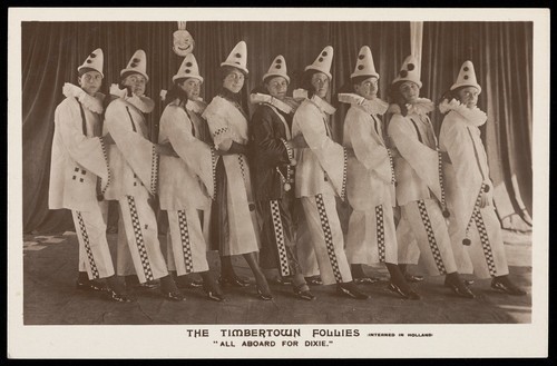 Download the full-sized image of Actors dressed as a clowns, performing for "The Timbertown Follies", at a prisoner of war camp in Groningen. Photographic postcard, 191-.