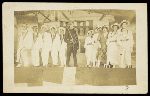 Download the full-sized image of Eleven sailors performing in a play on the Ark Royal. Photographic postcard, 191-.