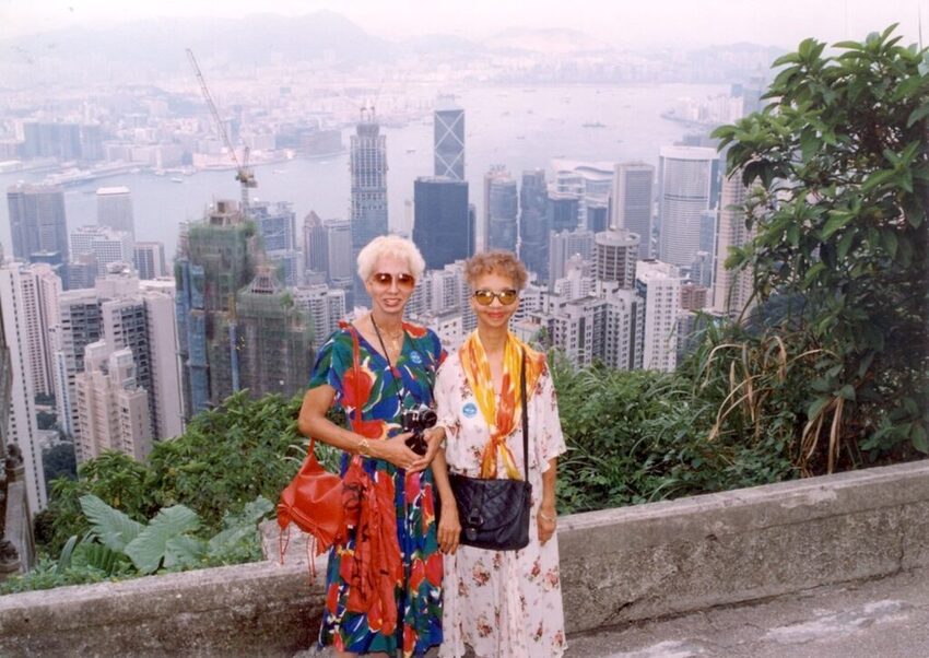 Download the full-sized image of A Photograph of Marlow Monique Dickson and a Friend Posing in front of a City Skyline