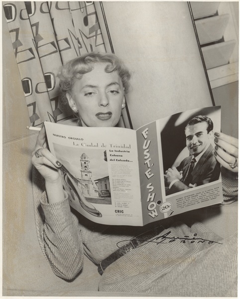 Download the full-sized image of Christine Jorgensen Reading a Magazine and Smoking