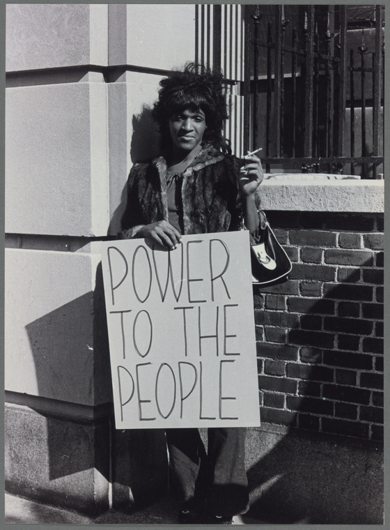 Download the full-sized image of A Photograph of Marsha P. Johnson Holding a Sign at a Picket