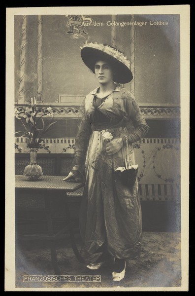 Download the full-sized image of A French prisoner of war posing in drag at a prisoner of war camp in Cottbus. Photographic postcard by P. Tharan, 191-.